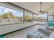 Inviting sunroom with tiled floors, wicker furniture, and a ceiling fan, offering a peaceful outdoor view at 2715 Pine Tree Dr, Edgewater, FL 32141