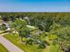 An aerial view of a home nestled among lush greenery, offering a serene setting at 3045 Pine Tree Dr, Edgewater, FL 32141