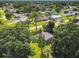 An aerial view shows a neighborhood filled with trees, lawns and homes with mature landscaping at 3045 Pine Tree Dr, Edgewater, FL 32141