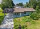 An aerial view of a single-story home with a spacious yard and covered carport at 3045 Pine Tree Dr, Edgewater, FL 32141
