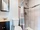 Well-lit bathroom features gray tile, shower and newer vanity at 3045 Pine Tree Dr, Edgewater, FL 32141