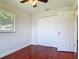 Bright bedroom features beautiful wood-look floors, ceiling fan and double door closet at 3045 Pine Tree Dr, Edgewater, FL 32141