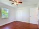 Bright bedroom features beautiful wood-look floors, ceiling fan and double door closet at 3045 Pine Tree Dr, Edgewater, FL 32141