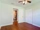 Bedroom with en-suite bathroom, closet, ceiling fan and hardwood floors, offering comfort and convenience at 3045 Pine Tree Dr, Edgewater, FL 32141