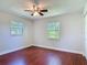 Bright bedroom features beautiful wood-look floors and dual windows for natural light at 3045 Pine Tree Dr, Edgewater, FL 32141