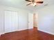 Bright bedroom features beautiful wood-look floors, ceiling fan and double door closet at 3045 Pine Tree Dr, Edgewater, FL 32141