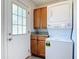 Functional laundry area with stacked washer and dryer plus storage at 3045 Pine Tree Dr, Edgewater, FL 32141