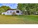 Charming white single-story home with mature trees and well-maintained lawn in a desirable location at 314 Carol Ann Dr, Edgewater, FL 32132