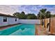 Refreshing private pool with a fence and green plants for privacy and beauty on a sunny day at 314 Carol Ann Dr, Edgewater, FL 32132