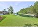 Expansive backyard with a picturesque pond and lush green landscaping at 3288 Spruce Creek Gln, Port Orange, FL 32128