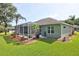 Lush green backyard with a screened lanai and well-manicured landscaping, offering a private outdoor space at 3288 Spruce Creek Gln, Port Orange, FL 32128