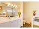 Bathroom with double vanity, granite counters, custom mirrors, garden tub, and walk-in shower at 3288 Spruce Creek Gln, Port Orange, FL 32128