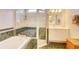 Bathroom with soaking tub and glass walk-in shower, double vanity at 3288 Spruce Creek Gln, Port Orange, FL 32128