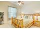 Bright bedroom with a decorative wood frame bed, light walls, and tile flooring at 3288 Spruce Creek Gln, Port Orange, FL 32128