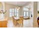 Bright dining area with tiled floors, ample seating, and a view to the front entrance at 3288 Spruce Creek Gln, Port Orange, FL 32128