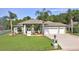 Charming single-story home with a 3-car garage, well-maintained lawn, and mature landscaping at 3288 Spruce Creek Gln, Port Orange, FL 32128