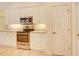 Bright kitchen features white cabinetry, stainless steel appliances, and tiled floor at 3288 Spruce Creek Gln, Port Orange, FL 32128