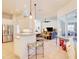Open concept kitchen with stainless steel appliances, tile floors, and a breakfast bar overlooking the living area at 3288 Spruce Creek Gln, Port Orange, FL 32128