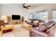 Bright living room with large windows, a comfortable couch and access to a patio at 3288 Spruce Creek Gln, Port Orange, FL 32128