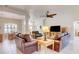 Comfortable living room featuring tile floors, a ceiling fan and an adjacent dining area at 3288 Spruce Creek Gln, Port Orange, FL 32128