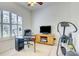 Comfortable office area with large windows, a ceiling fan, and neutral colors at 3288 Spruce Creek Gln, Port Orange, FL 32128