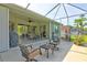 Spacious screened patio with outdoor seating, a ceiling fan, and a grill at 3288 Spruce Creek Gln, Port Orange, FL 32128