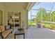 Relaxing screened patio with a view of the pond and backyard landscaping at 3288 Spruce Creek Gln, Port Orange, FL 32128