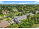 This is an aerial view of the property in a lush neighborhood with mature trees and a golf course at 343 Sweet Bay Ave, New Smyrna Beach, FL 32168