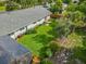 Aerial view of the home showcasing a well-manicured lawn, screened enclosure and mature trees at 343 Sweet Bay Ave, New Smyrna Beach, FL 32168