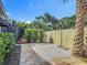 Landscaped backyard with a gravel area, wooden fence, and lush green bushes at 343 Sweet Bay Ave, New Smyrna Beach, FL 32168