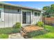 Inviting backyard deck with lush plants, steps to the yard, and access to the house at 343 Sweet Bay Ave, New Smyrna Beach, FL 32168