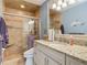 Bathroom featuring a granite countertop, white cabinets, and a glass-enclosed tiled shower at 343 Sweet Bay Ave, New Smyrna Beach, FL 32168