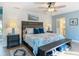 Bright bedroom with a coastal aesthetic, shiplap wall, and a view to the en-suite bathroom at 343 Sweet Bay Ave, New Smyrna Beach, FL 32168
