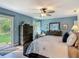 Spacious bedroom with natural light, wood floors, dresser, and walk-out access to outdoor space at 343 Sweet Bay Ave, New Smyrna Beach, FL 32168