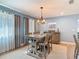 The dining room includes a wooden table and chairs, contemporary chandelier, and decorative curtains at 343 Sweet Bay Ave, New Smyrna Beach, FL 32168