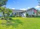 Charming single-story home with a well-manicured lawn, lush landscaping, and inviting curb appeal at 343 Sweet Bay Ave, New Smyrna Beach, FL 32168