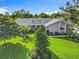 Beautifully landscaped front yard with lush green lawn and mature trees enhancing the curb appeal at 343 Sweet Bay Ave, New Smyrna Beach, FL 32168
