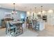Open concept kitchen with a large island, dining table, pendant lights, and white cabinetry at 343 Sweet Bay Ave, New Smyrna Beach, FL 32168