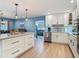 Charming kitchen displays granite countertops, a central island, and easy access to an adjacent dining area at 343 Sweet Bay Ave, New Smyrna Beach, FL 32168