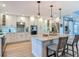 Modern kitchen boasts white cabinets, stainless steel appliances, and granite countertops at 343 Sweet Bay Ave, New Smyrna Beach, FL 32168