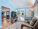 Living room with a comfortable leather sofa, sliding glass doors, and view to the dining room at 343 Sweet Bay Ave, New Smyrna Beach, FL 32168