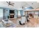 Bright living room with a cozy fireplace, tile floors, and open floor plan to the dining area at 343 Sweet Bay Ave, New Smyrna Beach, FL 32168