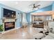 Open-concept living room featuring a fireplace, ample seating, and connection to the dining area at 343 Sweet Bay Ave, New Smyrna Beach, FL 32168