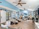Bright living room features vaulted ceilings, modern furniture, luxury floors, and a sliding barn door at 343 Sweet Bay Ave, New Smyrna Beach, FL 32168