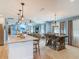 Open-concept living space with kitchen island, dining area, and living room visible in one shot at 343 Sweet Bay Ave, New Smyrna Beach, FL 32168