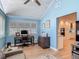 Bright office space with a wooden desk, natural light, and direct access to the kitchen at 343 Sweet Bay Ave, New Smyrna Beach, FL 32168