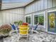 Charming outdoor patio with comfortable seating and view of the landscaped garden at 343 Sweet Bay Ave, New Smyrna Beach, FL 32168