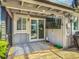 Covered patio with a large TV, outdoor fan, and sliding glass door access to the house at 343 Sweet Bay Ave, New Smyrna Beach, FL 32168