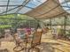 Spacious, enclosed patio area featuring outdoor dining and living area with lush yard views at 343 Sweet Bay Ave, New Smyrna Beach, FL 32168