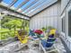 Cozy outdoor patio features stone flooring and comfortable seating area with a pergola at 343 Sweet Bay Ave, New Smyrna Beach, FL 32168